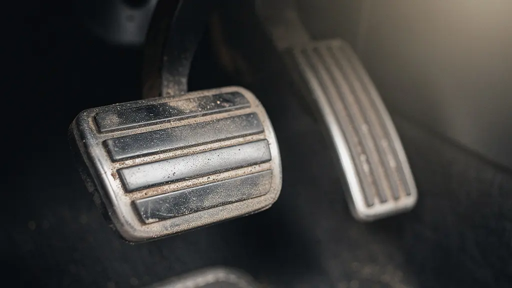 Gros plan sur les pédales usées d'une voiture d'occasion, révélant l'usure réelle du véhicule malgré un kilométrage affiché faible